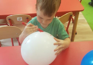 Tymek maluje balona.